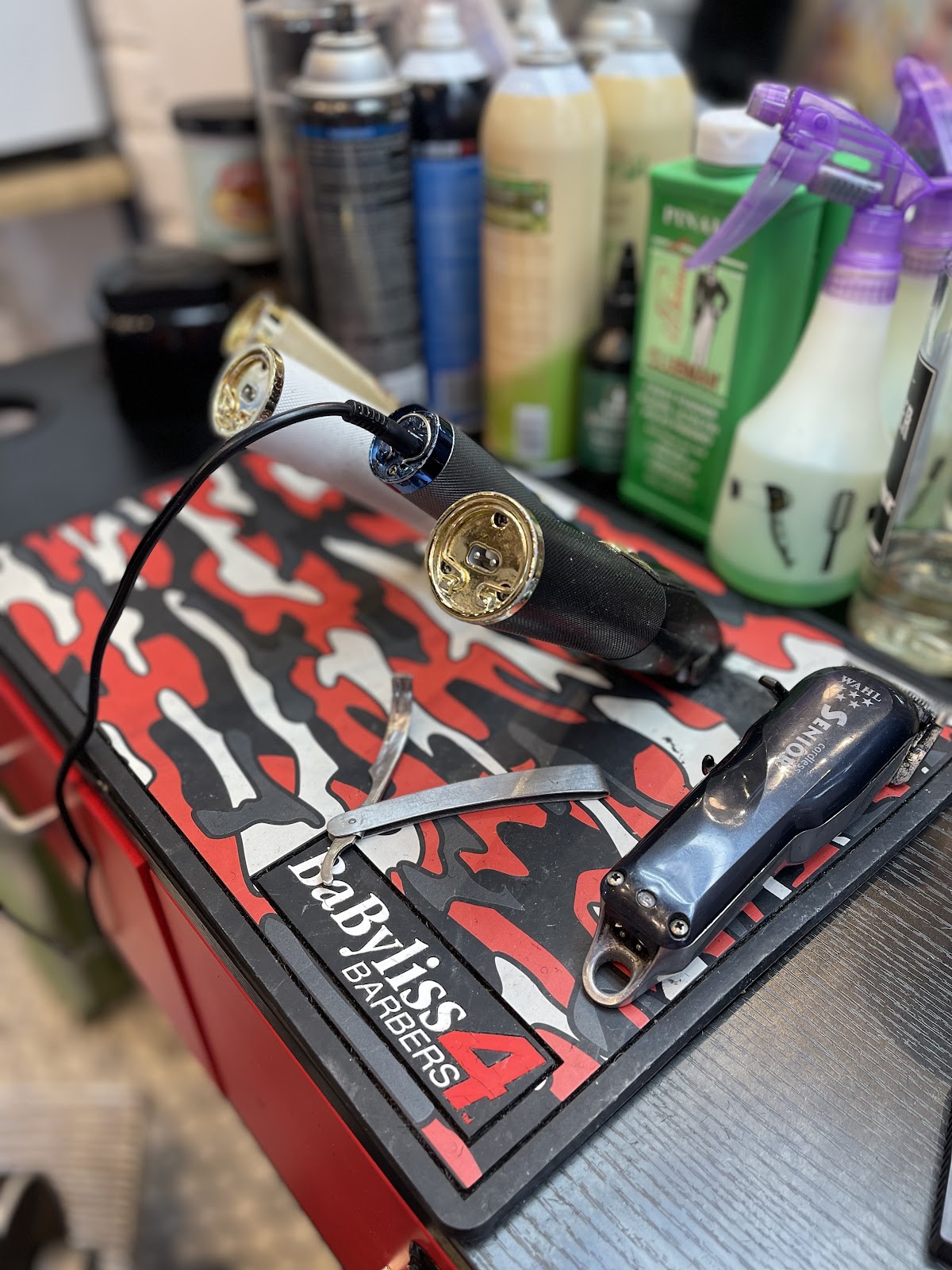 BabylissPRO and Wahl Senior clippers on a red and black camo Babyliss mat